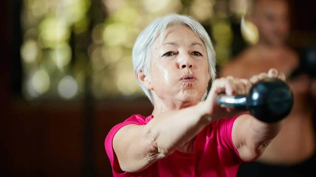 Toning Bingo Wings: Effective Exercises and Tips for Achieving Sleeker Arms 2 Person performing arm exercises with dumbbells West Sussex